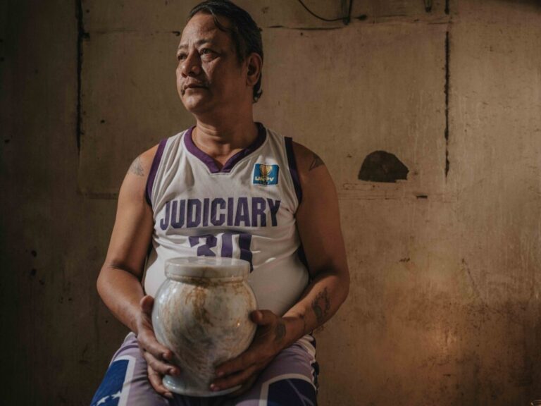February 25, 2025. Quezon City, Philippines. Arthur R. Caballero holds the urn containing the ashes of his mother, Erma R. Caballero, in a quiet moment of remembrance. The funeral service, provided free of charge by the Mayor of Quezon City, is part of a local initiative aimed at supporting families who cannot afford funeral expenses. This program offers dignified services to those in need, ensuring that no one is denied a proper farewell for their loved ones due to financial hardship. Photo Credit: Juan Arredondo.