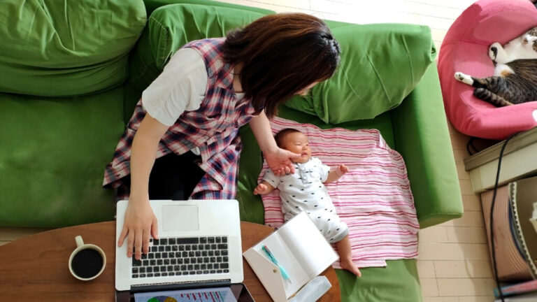 Mother taking care of baby while working