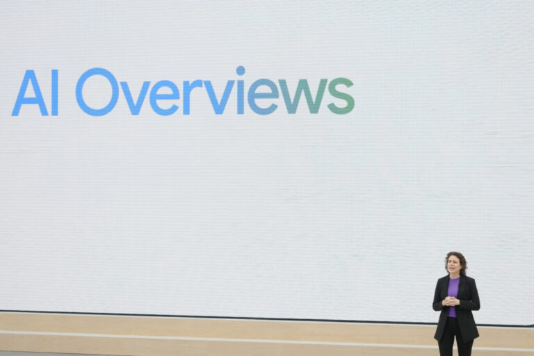 Liz Reid, Google's head of search, speaks at a Google I/O event in Mountain View, California, on May 14, 2024. Reid is standing on the right side of the frame, and behind her is a giant backdrop that says