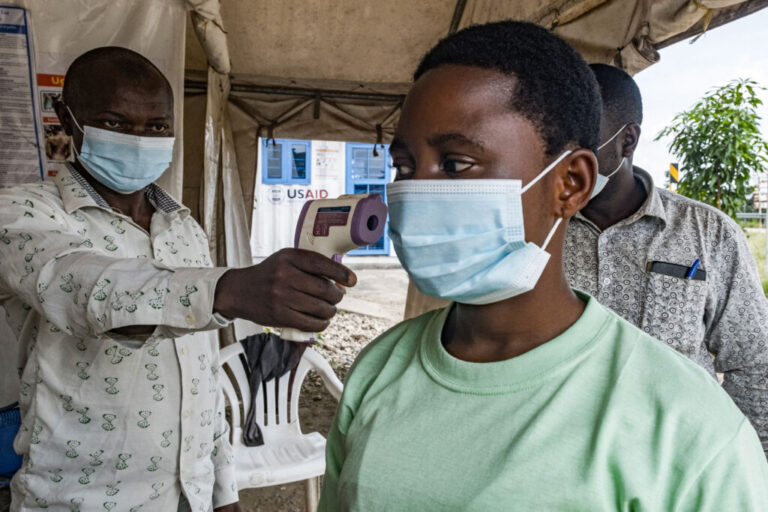 A border health officer at the Busunga crossing between Uganda and the Democratic Republic of Congo checks a traveler's temperature using a contactless infrared thermometer in Bundibugyo, on May 18, 2026. Ugandan officials confirmed that a 59-year-old man from Democratic Republic of Congo had died in Kampala after being admitted earlier in the week. Tests showed the victim in Uganda was infected with the Bundibugyo strain of Ebola, first identified in 2007. The World Health Organization declared an international health emergency on May 17, 2026 over an outbreak of an Ebola strain in the Democratic Republic of Congo that has killed more than 80 and for which there is no vaccine. Fears of further spread grew when a laboratory confirmed a case in the major eastern DRC city of Goma, which is controlled by the Rwanda-backed M23 militia.