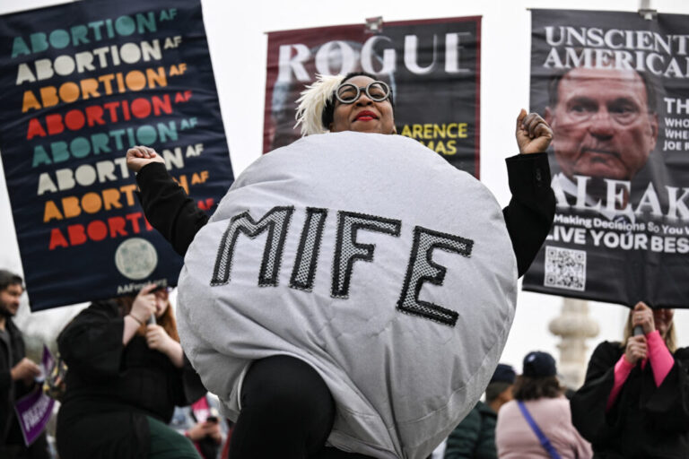 A woman dressed as a mifepristone pill is at rally outside the US Supreme Court on April 2, 2025.
