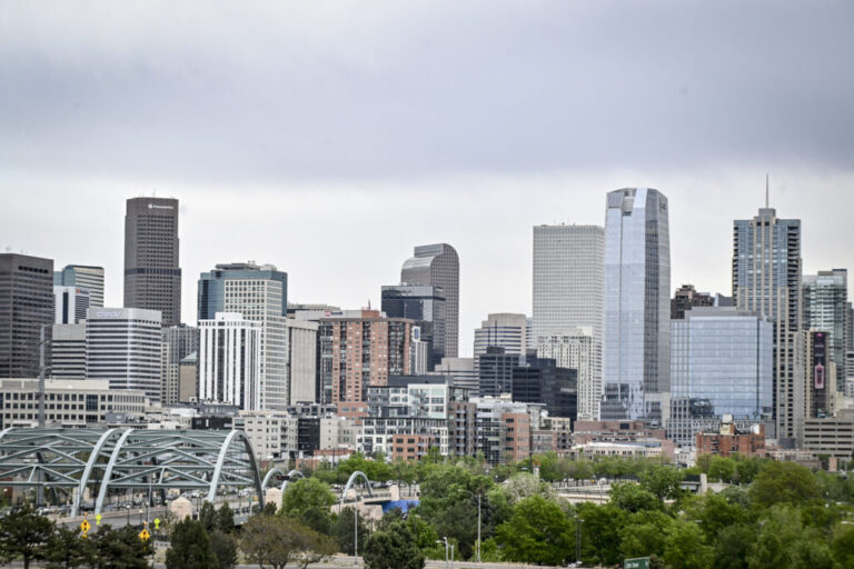 This photo shows the skyline of Denver, with many tall and modern buildings.