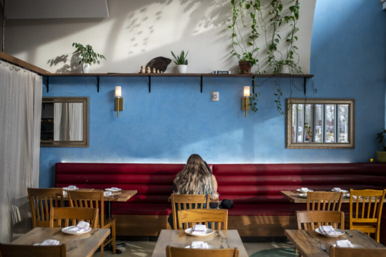 Two guests sit at a table at L'Oca d'Oro on Tuesday, Feb. 17, 2026, in Austin, TX. L'Oca d'Oro offers a Tuesday evening promotion where guests can pay what they want. With rising food costs, more Americans are staying home rather than going out to dinner. Sergio Flores/NPR