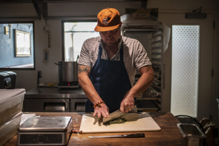 Fiore Tedesco chops rosemary at L'Oca d'Oro on Tuesday, Feb. 17, 2026, in Austin, TX. L'Oca d'Oro offers a Tuesday evening promotion where guests can pay what they want. With rising food costs, more Americans are staying home rather than going out to dinner. Sergio Flores/NPR