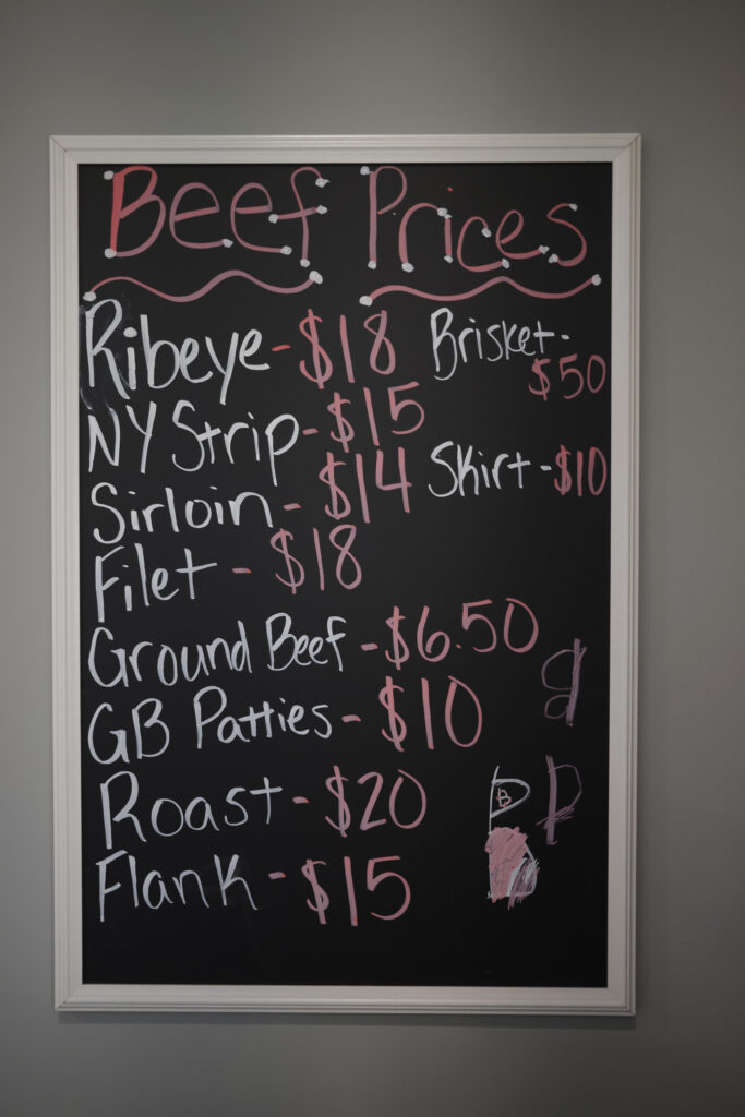 A chalkboard with handwritten beef prices is seen at Hallstead Farms. Prices range from $50 for brisket to $6.50 for ground beef.