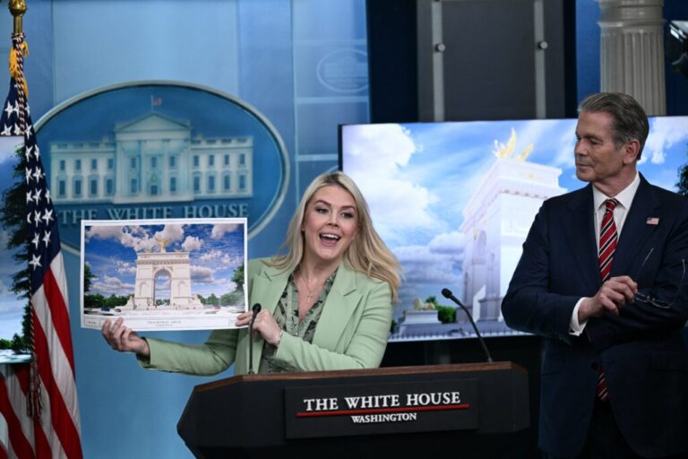 White House press secretary Karoline Leavitt shows a rendering of the planned triumphal arch to be added near Washington, D.C.'s National Mall as the Secretary of the Treasury, Scott Bessent, looks on at a meeting on Wednesday.