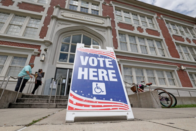 People walk into a New Orleans school to cast their votes in Louisiana's statewide primary on May 16.