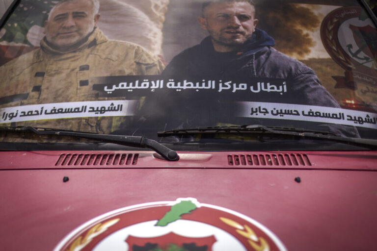 Nabatiyeh, Lebanon — May 13, 2026. Pictures of Lebanese Civil Defense members Hussein Jaber and Ahmad Noura, who were killed in an Israeli strike on the southern town of Nabatieh on May 12, 2026, displayed on an ambulance. Diego Ibarra Sánchez for NPR.