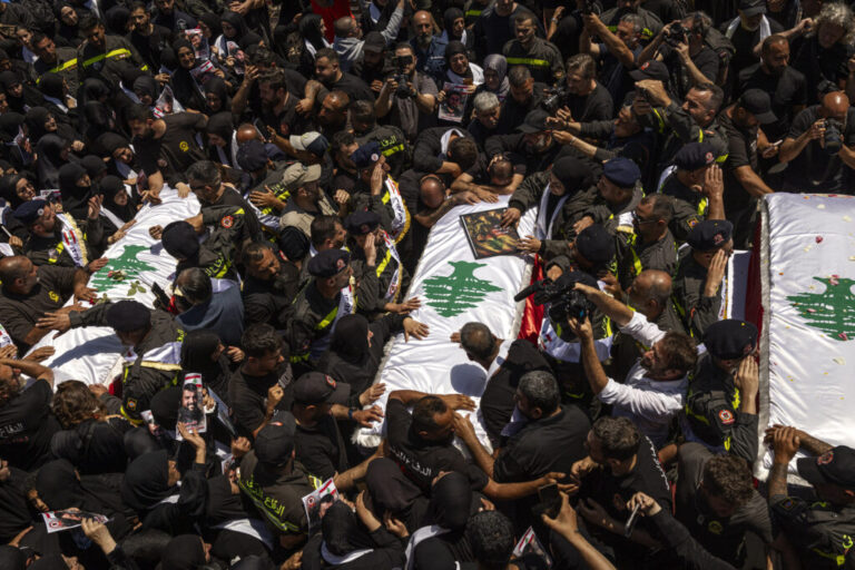 Hundreds of mourners marched on Thursday behind the coffins of three Lebanese Civil Defense paramedics killed by Israeli strikes in southern Lebanon. Their fellow paramedics, dressed in uniform, carried the coffins draped with Lebanese flags on their shoulders and saluted them, while mourners wept.