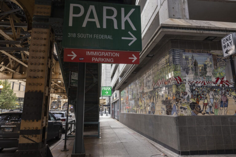 Signs direct traffic to the immigration court parking lot in Chicago, Ill., in August 2024.
