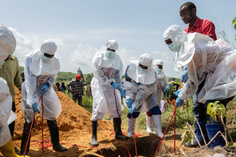 Red Cross workers bury an Ebola victim at the Rwampara Cemetery, in Rwampara, Congo, May 23, 2026.