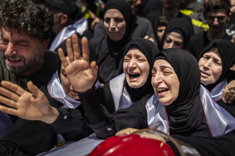 Mourners, relatives and collagees attend the funeral in Saida, Lebanon on May 13, 2026 of Lebanese civil defense members Hussein Jaber and Ahmad Noura, who were killed in an Israeli strike on the southern town of Nabatieh the day before.