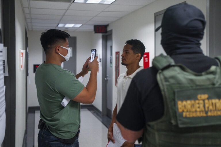 An Immigration and Customs Enforcement (ICE) agent uses facial recognition software to confirm an asylum seeker's identity prior to an immigration hearing on July 30, 2025, in New York. In addition, DHS is expanding its use of iris scanners to help quickly identify undocumented immigrants.