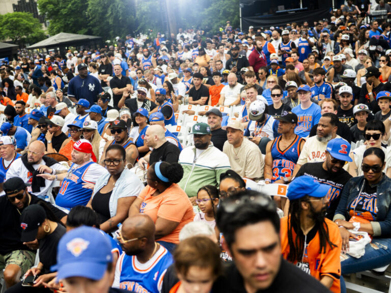 New York Knick fans, including Ghostface Killah and The RZA of Wu-Tang Clan, celebrate the Knicks' 2026 NBA Championship win with a ticker tape parade at City Hall.