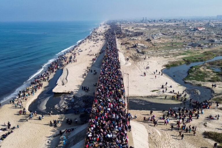 This aerial photo shows displaced Gazans walking toward Gaza City on Jan. 27, 2025, after crossing the Netzarim corridor from the southern Gaza Strip.