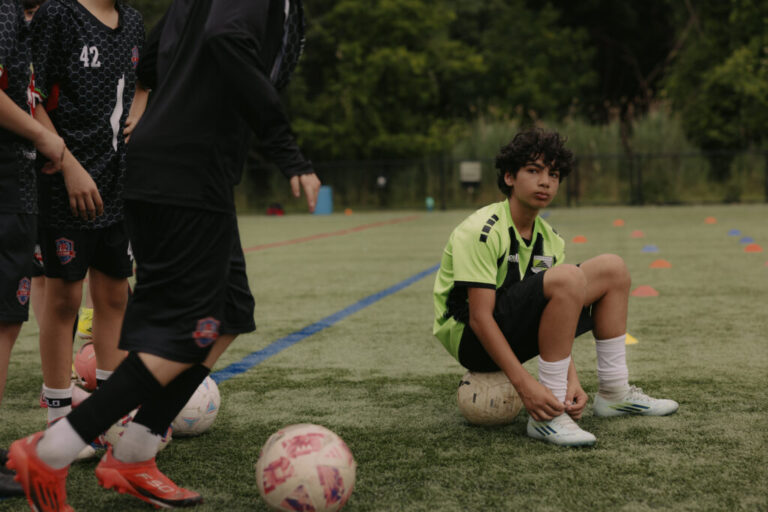 Taim Nadin, 13, center, sits for a portrait during an evening practice with the Palestino Soccer Academy at Frank D Zaccaria Memorial Park in Woodland Park, New Jersey, U.S., on Saturday, June 6, 2026. CREDIT: José A. Alvarado Jr. for NPR, @josealvarado