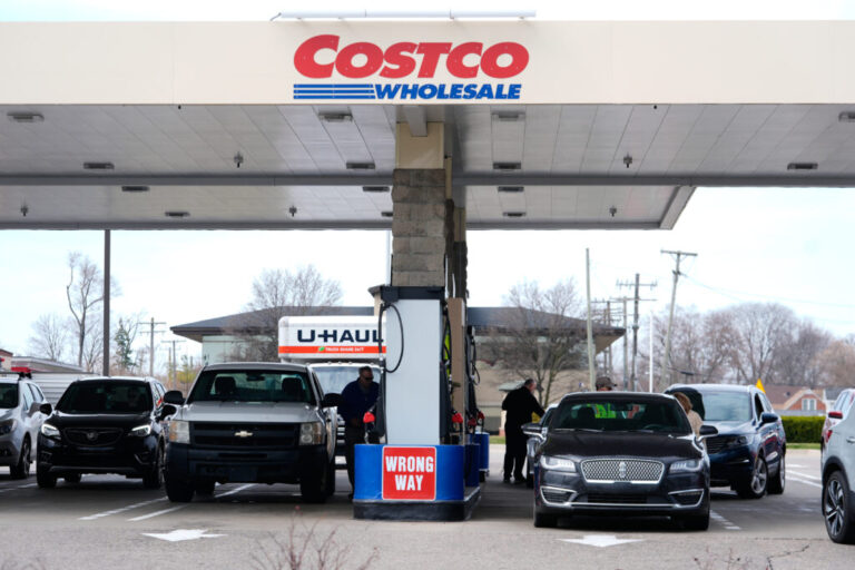 Drivers fuel up at a Costco gas station in Roseville, Mich.
