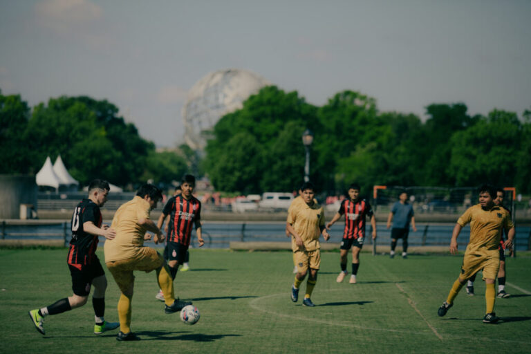 Members of the Fuego FC play against Strong Blood FC on field 5 in Flushing Meadows Corona Park as commotion from echoes off the multiple fields hosting adult recreational league soccer matches in Queens, New York, U.S., on Sunday, June 7, 2026. CREDIT: José A. Alvarado Jr. for NPR, @josealvarado