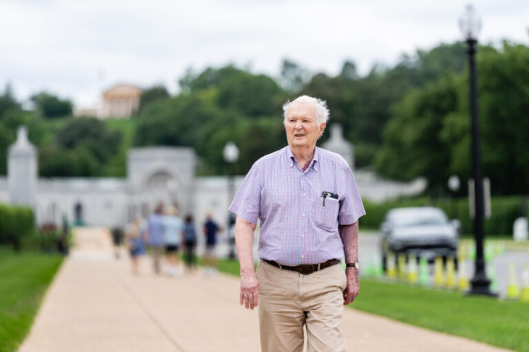 Shaun Byrnes, 83, a U.S. Navy veteran who served in Vietnam, arrives for an interview near Arlington National Cemetery in Arlington, Virginia on Monday, June 8, 2026. Public Citizen, representing Byrnes and other veterans, are suing the Trump administration to block construction of the proposed Triumphal Arch in Memorial Circle. (Eric Lee for NPR)