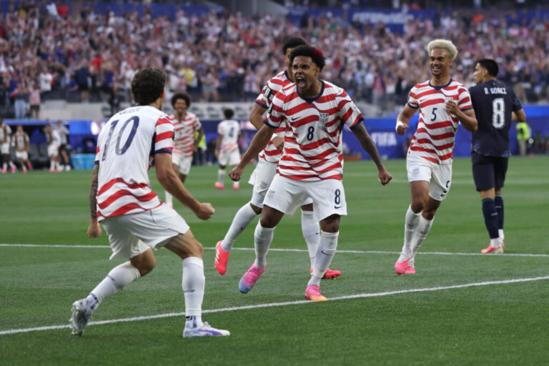 Christian Pulisic #10 and Weston McKennie #8 of the United States celebrate their side's first goal, an own goal by Damian Bobadilla of Paraguay (not pictured), to go ujp 1-0 in the 7th minute during the FIFA World Cup 2026 Group D match between USA and Paraguay at Los Angeles Stadium on Friday.