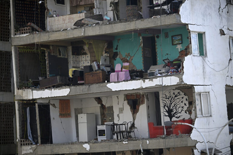A view shows the interior of a heavily damaged apartment building following an earthquake.