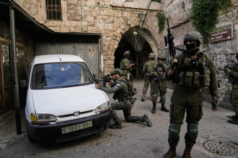 Israeli soldiers take up positions during an army raid in the West Bank town of Nablus, Feb. 11, 2026.