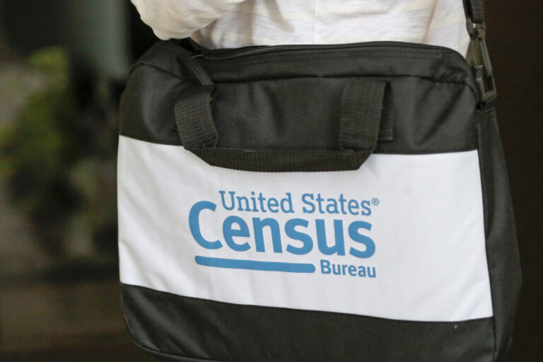The U.S. Census Bureau’s logo is featured on a black bag carried by a census worker knocking on doors in 2020 in Winter Park, Florida.