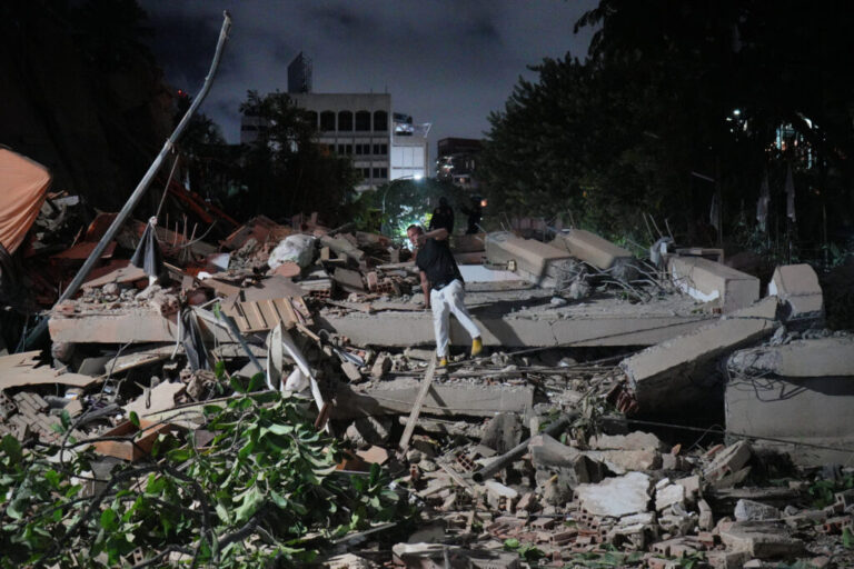 A man jumps on a collapsed building after an earthquake in Caracas, Venezuela.