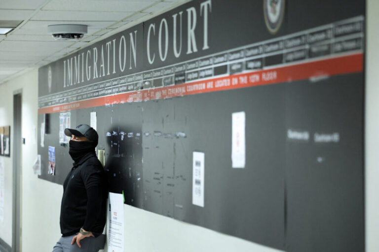 A federal officer stands in a hallway at New York Federal Plaza Immigration Court inside the Jacob K. Javitz Federal Building in New York in October 2025.