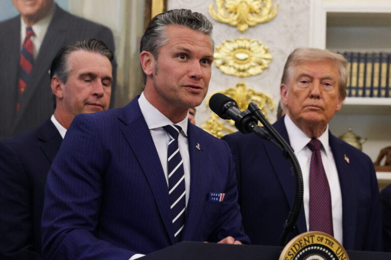 U.S. Defense Secretary Pete Hegseth speaks as President Trump looks on in the Oval Office at the White House on Sept. 2., 2025 in Washington, D.C.