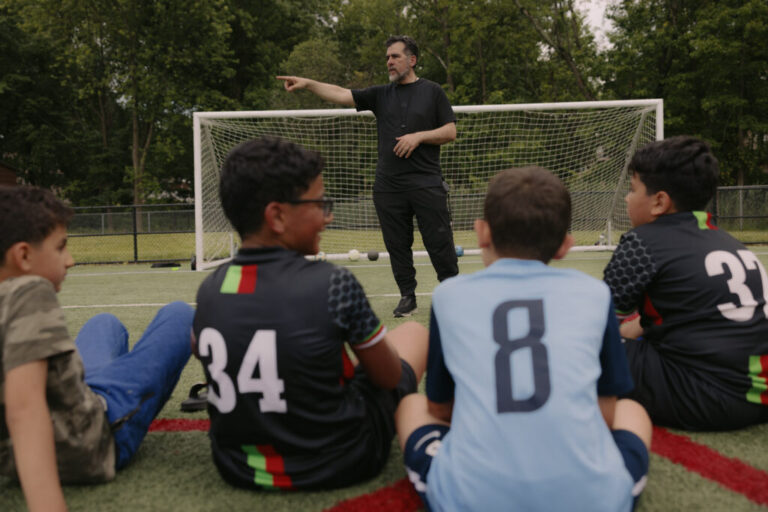 Coach Omar Almashni, center, leads a practice with the Palestino Soccer Academy at Frank D Zaccaria Memorial Park in Woodland Park, New Jersey, U.S., on Saturday, June 6, 2026. CREDIT: José A. Alvarado Jr. for NPR, @josealvarado