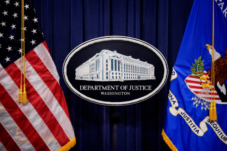 The Department of Justice logo is displayed before U.S. Attorney General Pam Bondi arrives for a news conference at the agency on May 6, 2025 in Washington, DC. The DOJ announced in a June memo that it is aggressively prioritizing efforts to strip some Americans of their U.S. citizenship.