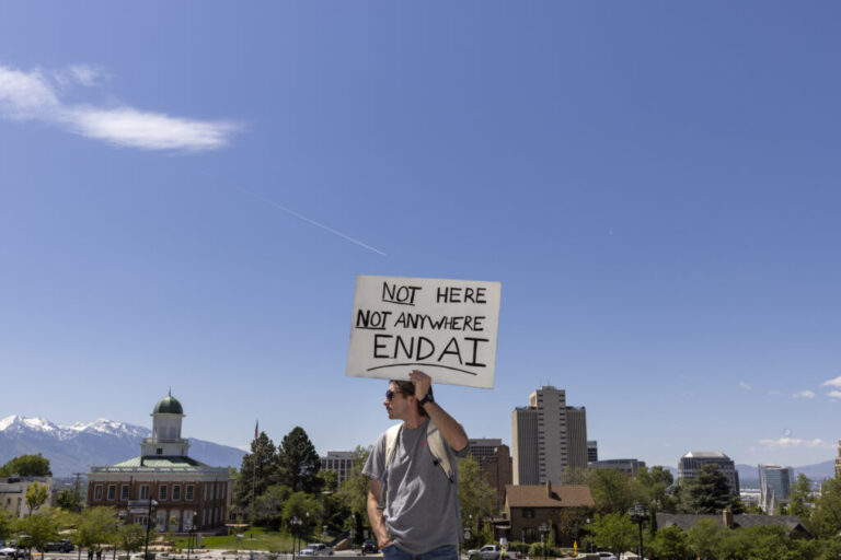 A man holds a sign that says