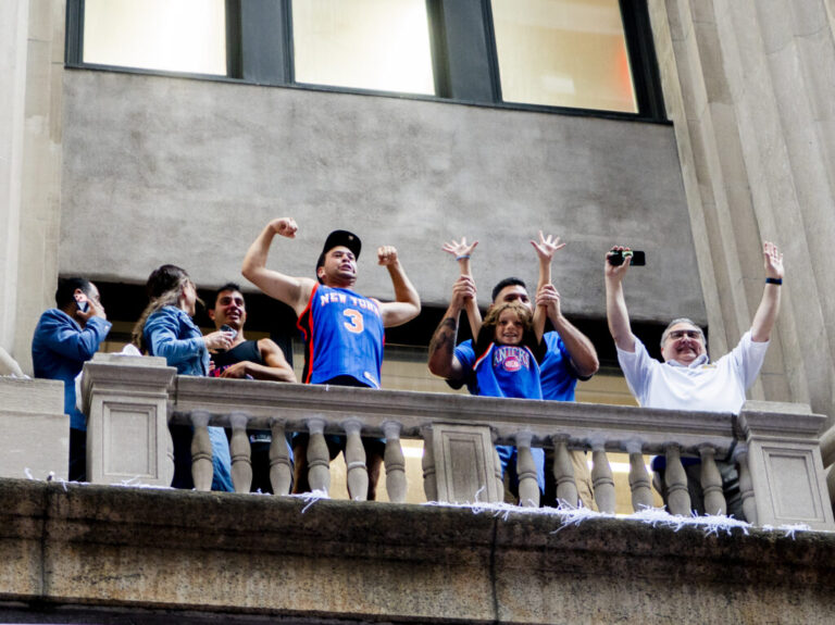 New York Knick fans celebrate winning the 2026 NBA Championship with a ticker tape parade at City Hall.