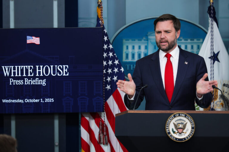 Vice President JD Vance speaks at a podium next to a sign that says
