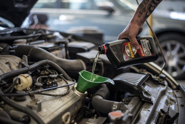 A mechanic pours motor oil into a funnel inside a Chevron Corp. gas station in Albuquerque, N.M., in July 2016. The cost of group III base oil, used in motor oil blends, more than tripled since the start of the war with Iran, according to the market insight firm Independent Commodity Intelligence Services.