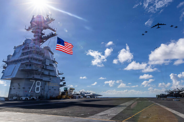 In this handout provided by the U.S. Navy, USS Gerald R. Ford, F/A-18E/F Super Hornets assigned to Strike Fighter Squadrons 31, 37, 87, and 213 from embarked Carrier Air Wing Eight, and a U.S. Air Force B-52 Stratofortress operate as a joint, multi-domain force on Nov. 13, 2025.
