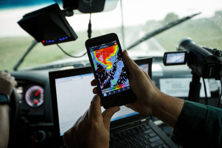 A scientist looks at radar on his phone while tracking a supercell thunderstorm in Oklahoma.
