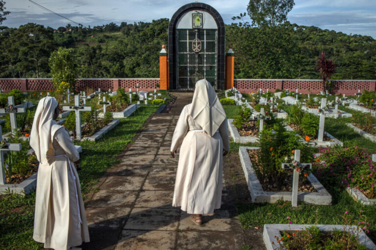 Sister Jean Francis, Superior General of the Little Sisters of St Francis, walks alongside another nun past a cemetery within the congregation’s premises in Nkokonjeru, Uganda, on May 11, 2026. The cemetery is where members of the congregation are laid to rest. The Little Sisters of St Francis, who have served in schools, clinics and communities across Uganda for decades, are now also focusing on care for aging and retired sisters, many of whom require increasing medical and end-of-life support after years of service.