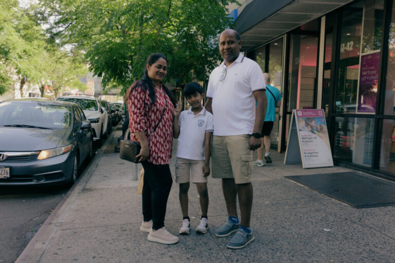 As commotion fills the air of Diversity Plaza, Gloria Rozario, left, Wilson Costa, center, and Shipu D. Costa, right, stand for a portrait outside of Diversity Plaza on 74 Street in Queens, New York, U.S., on Sunday, June 7, 2026. CREDIT: José A. Alvarado Jr. for NPR, @josealvarado