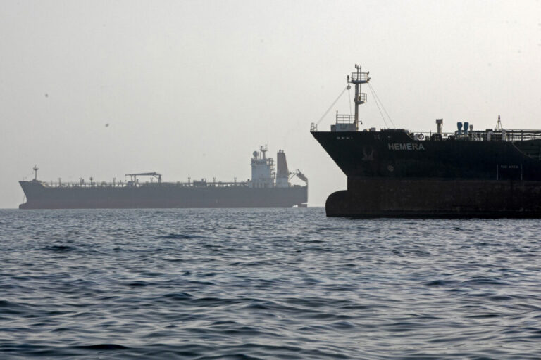 A ship remains anchored on May 16 in the Strait of Hormuz near Larak Island, Iran. A second ship floats in the background.