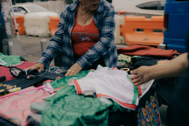 Eloidia, center, sell various Mexico themed items and soccer jerseys at Corona Plaza as residents navigate the bustling plaza in Queens, New York, U.S., on Sunday, June 7, 2026. CREDIT: José A. Alvarado Jr. for NPR, @josealvarado