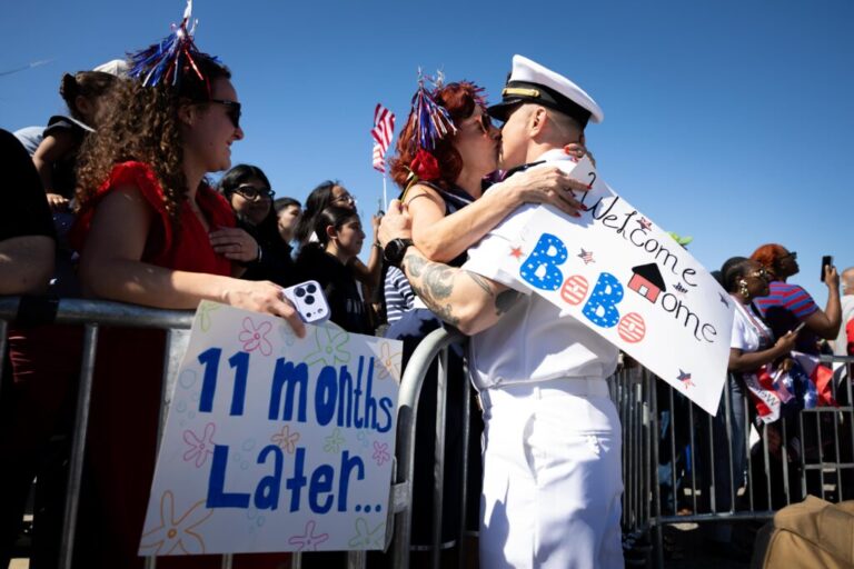 Juan Caceres kisses Heidi Eckstein after disembarking aircraft carrier USS Gerald R. Ford at Naval Station Norfolk on May 16 in Norfolk, Va.