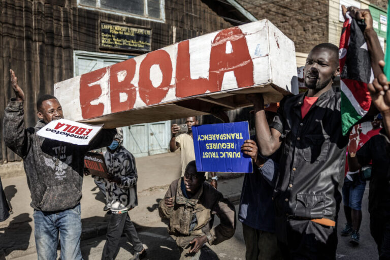 TOPSHOT - Protesters carry a mock coffin as they march during a demonstration against a controversial US-built Ebola quarantine centre slated to begin operations at Laikipia Air Base in Nanyuki on June 9, 2026. Several Kenyans were arrested on June 9, 2026 in the latest protests against an Ebola quarantine centre being built for US citizens in a tourist town. The centre at Laikipia Air Base in the town of Nanyuki, under the shadow of Mount Kenya, is set to quarantine Americans arriving from the Democratic Republic of Congo (DRC), which is battling a major Ebola outbreak.