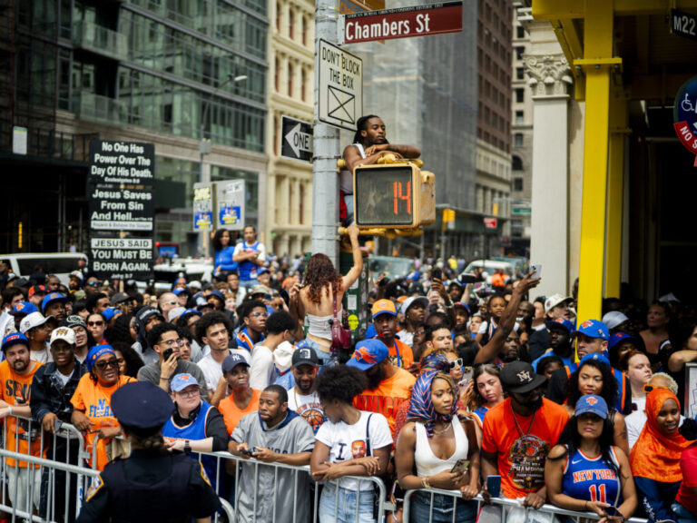 New York Knick fans celebrate winning the 2026 NBA Championship with a ticker tape parade at City Hall.