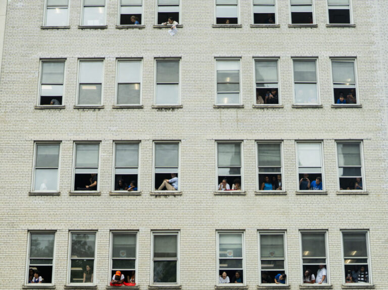 Fans watch the New York Knicks ticker tape parade at City Hall.