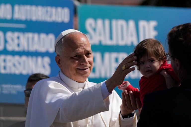 Pope Leo XIV blesses a child during a meeting with migrants at the 'Las Raices' center, in San Cristobal de la Laguna in Spain.