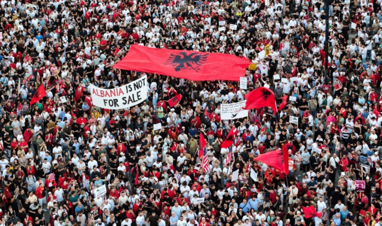 A drone view shows protesters gathered outside the Prime Minister's Office in Tirana, Albania, on June 10, 2026, during the tenth consecutive day of demonstrations against a proposed luxury tourism development project linked to Jared Kushner. Organizers say thousands of people attend the rally.