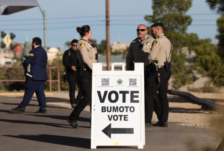 Police officers stand outside a polling station in Las Vegas on Election Day, Nov. 5, 2024. In recent years, election administrators have formed closer working relationships with local law enforcement.