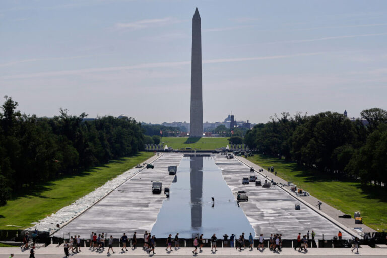 Workers refill the Lincoln Memorial Reflecting Pool on Friday, after weeks of resurfacing.